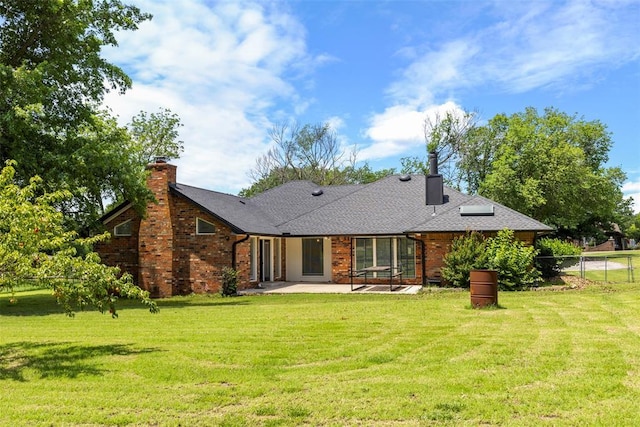 57 Serenada Ln, Shawnee, OK 74804 - back of property with a patio, a chimney, and brick siding