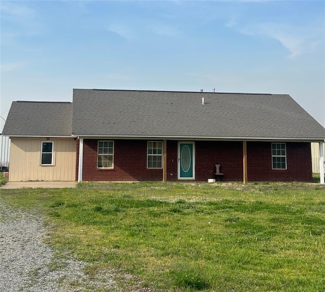 view of front of property with a front lawn and brick siding