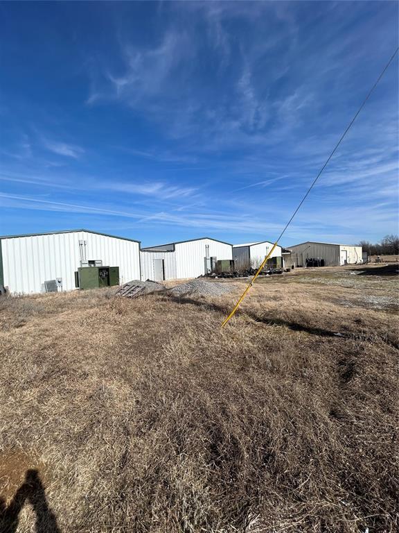 view of yard with an outbuilding and a pole building