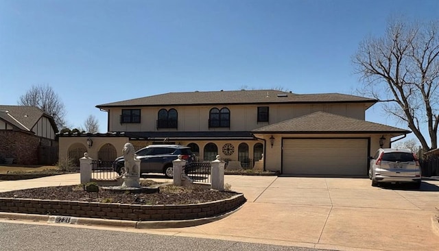 9721 N Lakeland Rd, Oklahoma City, OK 73162 - view of front facade featuring concrete driveway, a garage, and a fenced front yard