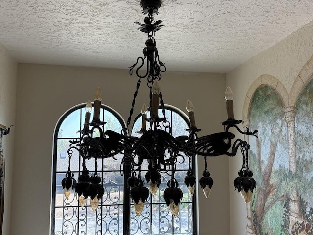 9721 N Lakeland Rd, Oklahoma City, OK 73162 - interior details with a notable chandelier and a textured ceiling