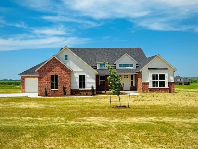 4337 Pinon Ln, Piedmont, OK 73078 - view of front of house featuring board and batten siding, brick siding, a front yard, and an attached garage