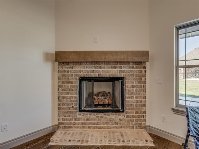 1209 Jozie Way, Tuttle, OK 73089 - room details with baseboards, a brick fireplace, and wood finished floors