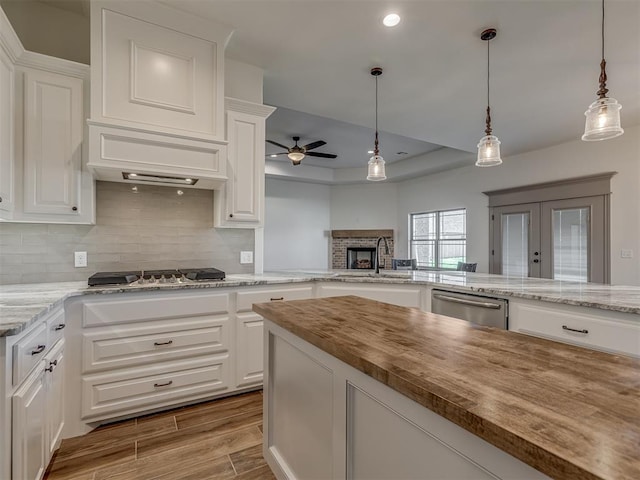 1209 Jozie Way, Tuttle, OK 73089 - kitchen with a sink, butcher block countertops, tasteful backsplash, a ceiling fan, and appliances with stainless steel finishes