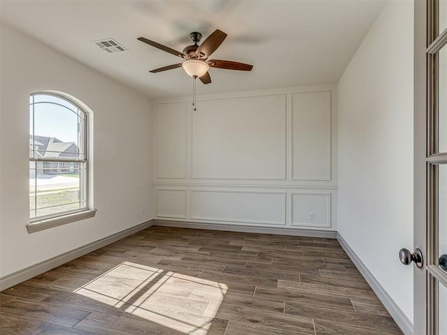 1209 Jozie Way, Tuttle, OK 73089 - empty room with baseboards, a ceiling fan, dark wood-type flooring, and visible vents
