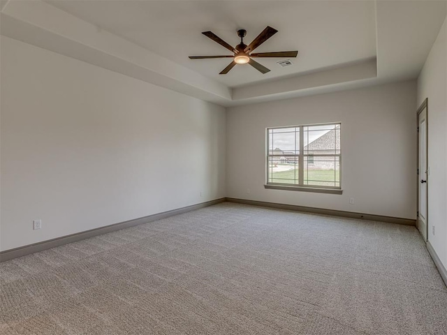 1212 Jaden Blvd, Tuttle, OK 73089 - unfurnished room featuring a ceiling fan, light carpet, a raised ceiling, and baseboards