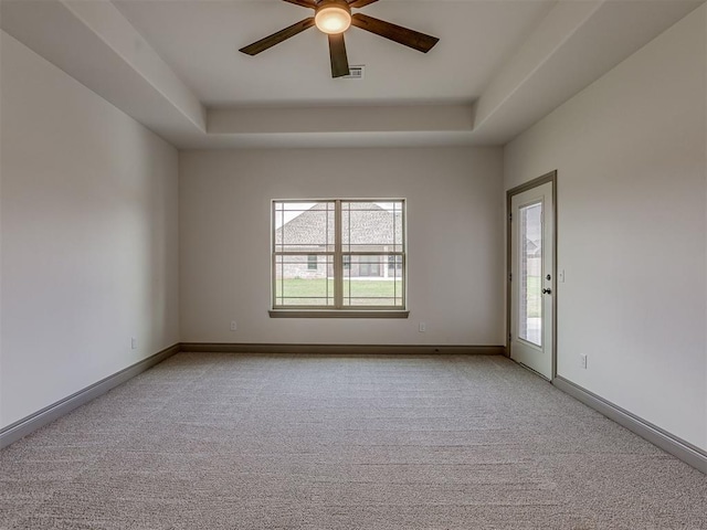 1212 Jaden Blvd, Tuttle, OK 73089 - unfurnished room with light carpet, ceiling fan, a raised ceiling, and baseboards