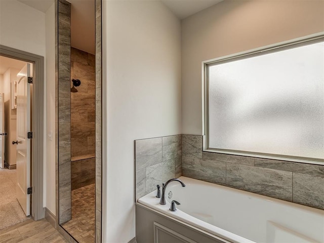 1212 Jaden Blvd, Tuttle, OK 73089 - full bathroom featuring a tile shower, a garden tub, and wood finished floors