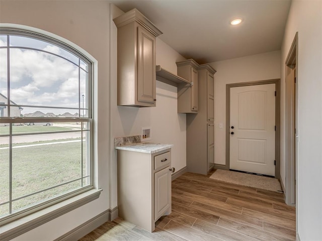 1212 Jaden Blvd, Tuttle, OK 73089 - laundry room featuring cabinet space, light wood-type flooring, and washer hookup