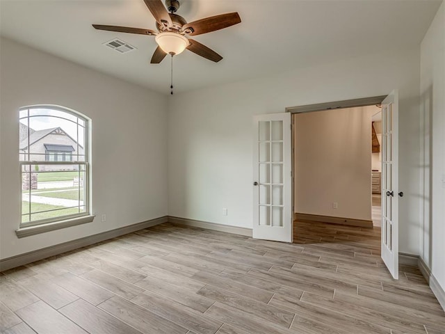 1212 Jaden Blvd, Tuttle, OK 73089 - empty room featuring french doors, light wood finished floors, ceiling fan, and baseboards