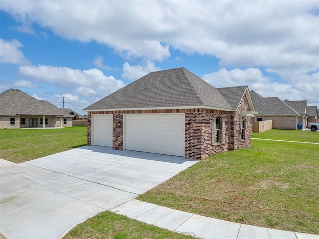 1212 Jaden Blvd, Tuttle, OK 73089 - view of side of home featuring a yard, a garage, brick siding, and driveway