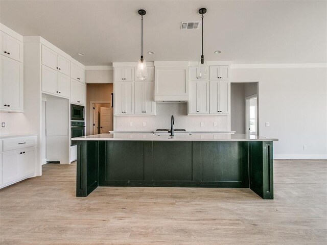 kitchen featuring backsplash, white cabinets, black microwave, and oven