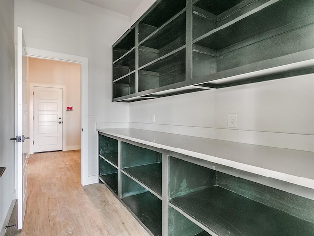 interior space with baseboards and wood finished floors