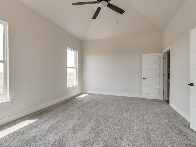 carpeted spare room featuring baseboards, lofted ceiling, and ceiling fan