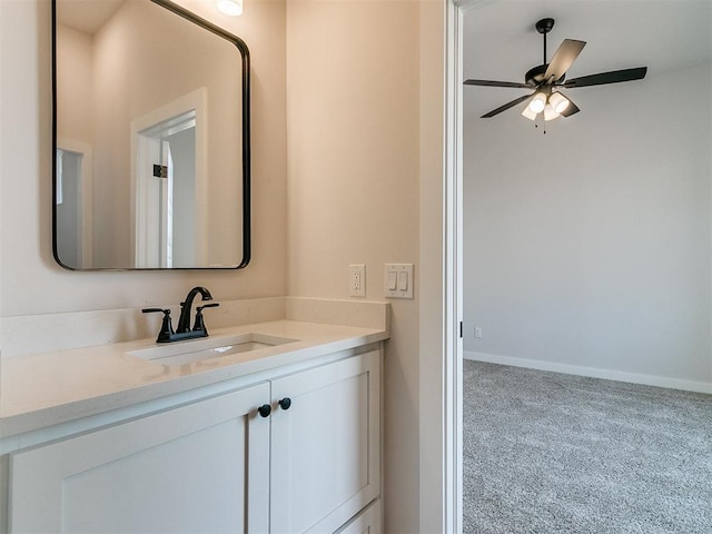 bathroom featuring baseboards, a ceiling fan, and vanity