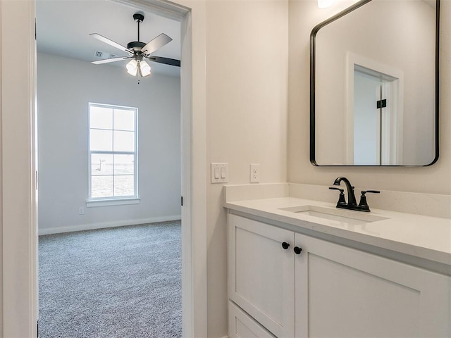 bathroom featuring vanity, visible vents, baseboards, and a ceiling fan