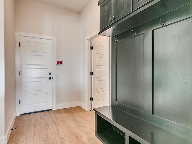 mudroom with baseboards and light wood-style floors