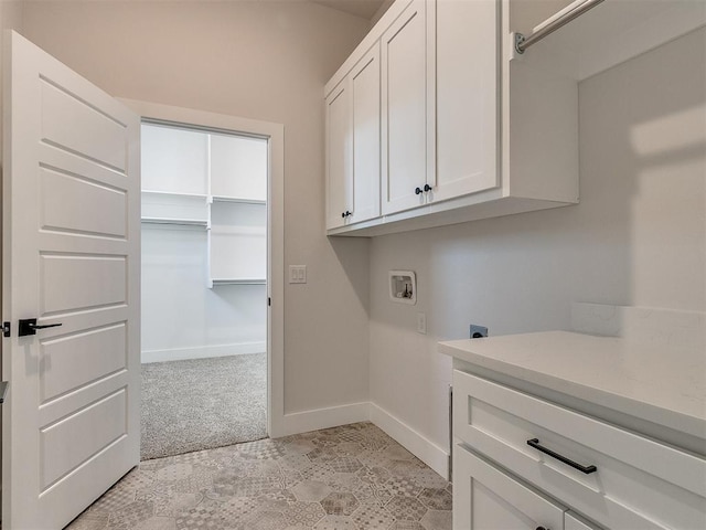 laundry area with hookup for an electric dryer, baseboards, cabinet space, light carpet, and washer hookup