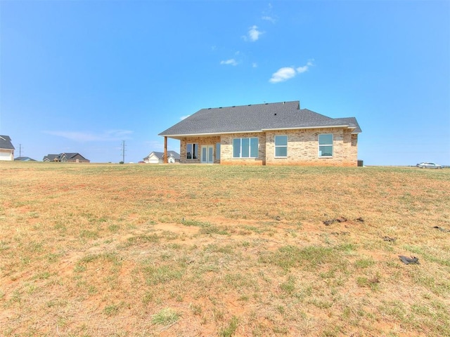 rear view of house with a lawn