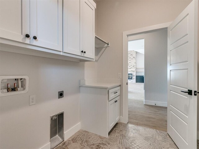 4253 Hawthorne St, Piedmont, OK 73078 - washroom featuring electric dryer hookup, cabinet space, baseboards, and washer hookup