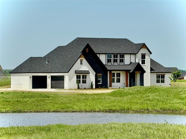 4175 White Ash Dr, Piedmont, OK 73078 - view of front facade with a garage, a water view, a front yard, and roof with shingles