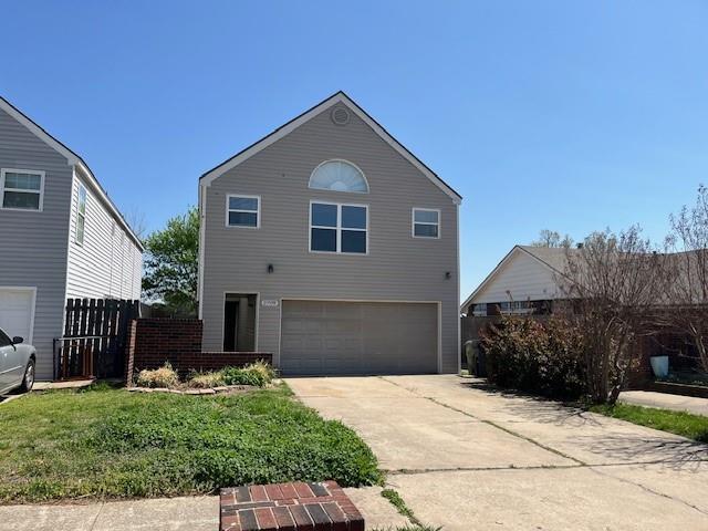 2709 Bishops Dr, Norman, OK 73072 - traditional home with concrete driveway, a front lawn, fence, and an attached garage