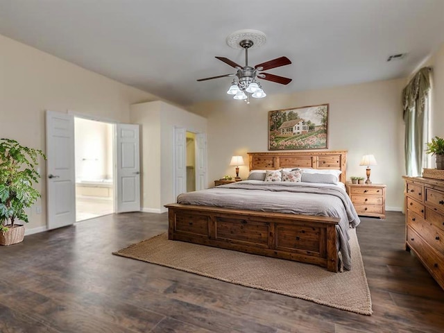 13216 SW 10th St, Yukon, OK 73099 - bedroom with dark wood-style floors, baseboards, connected bathroom, and ceiling fan