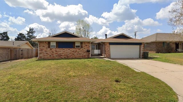 1313 Kingston Dr, Yukon, OK 73099 - ranch-style home with concrete driveway, a front yard, brick siding, and an attached garage