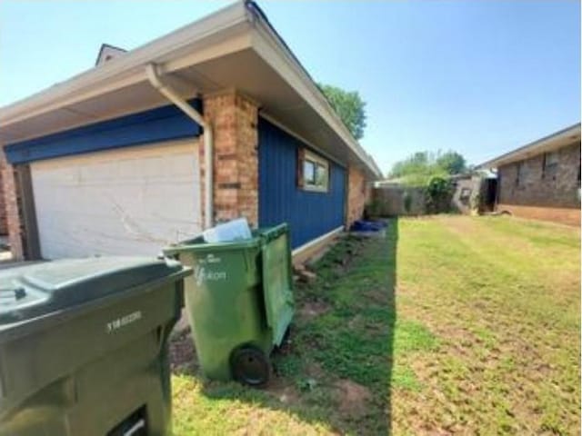 1313 Kingston Dr, Yukon, OK 73099 - view of home's exterior featuring a yard and a garage