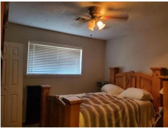 1313 Kingston Dr, Yukon, OK 73099 - bedroom with ceiling fan and visible vents