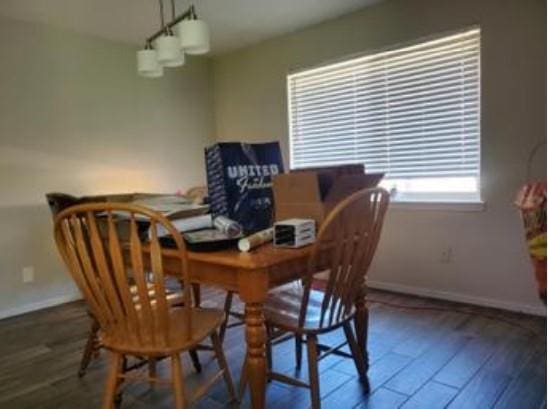 1313 Kingston Dr, Yukon, OK 73099 - dining area featuring baseboards and wood finished floors