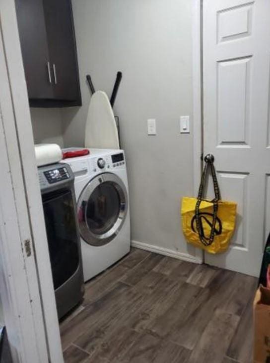 1313 Kingston Dr, Yukon, OK 73099 - laundry room with washing machine and dryer, dark wood finished floors, and cabinet space