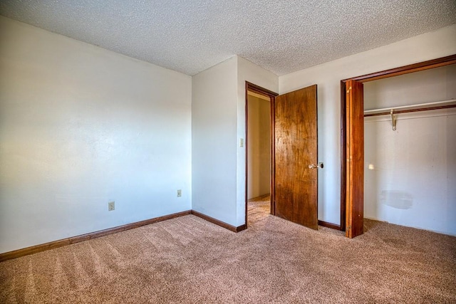 834 Mimosa Dr, Watonga, OK 73772 - unfurnished bedroom with baseboards, a closet, carpet, and a textured ceiling