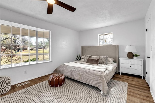 636 E Lea Ter, Mustang, OK 73064 - bedroom with wood finished floors, baseboards, and ceiling fan