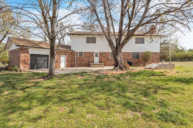 636 E Lea Ter, Mustang, OK 73064 - rear view of house with brick siding, a lawn, a garage, and a chimney
