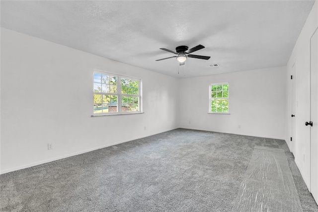 636 E Lea Ter, Mustang, OK 73064 - spare room featuring carpet floors, a ceiling fan, baseboards, and a textured ceiling