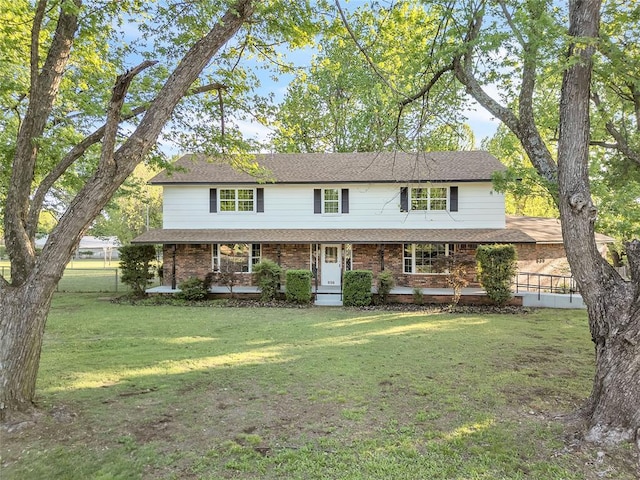 636 E Lea Ter, Mustang, OK 73064 - view of front facade featuring covered porch, a front lawn, and brick siding