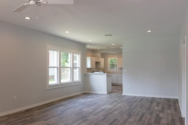 unfurnished living room with dark wood-style flooring, baseboards, recessed lighting, a ceiling fan, and visible vents