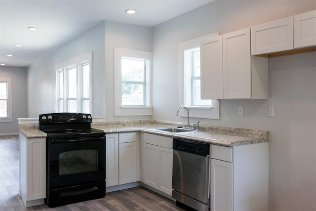kitchen featuring recessed lighting, wood finished floors, dishwasher, a sink, and black range with electric cooktop