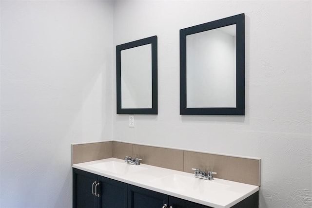bathroom featuring double vanity and a sink