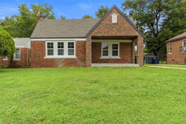 view of front of house featuring roof with shingles, a chimney, a front lawn, and brick siding