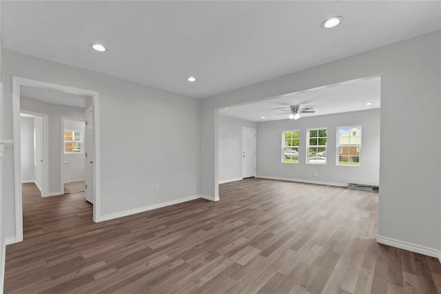 unfurnished living room featuring baseboards, recessed lighting, wood finished floors, and a ceiling fan