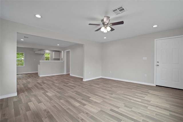 unfurnished living room with visible vents, baseboards, light wood finished floors, and ceiling fan