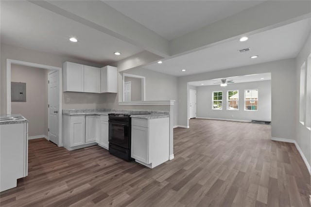kitchen featuring dark wood-style flooring, visible vents, ceiling fan, and black range with electric cooktop