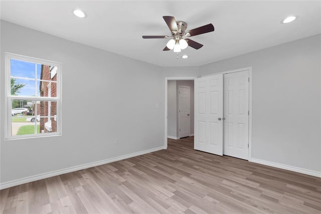 unfurnished bedroom featuring light wood-type flooring, baseboards, a ceiling fan, and recessed lighting