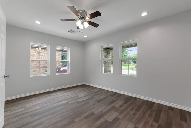 unfurnished room with visible vents, baseboards, a ceiling fan, and wood finished floors