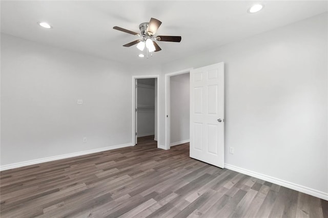 unfurnished bedroom with ceiling fan, a closet, recessed lighting, wood finished floors, and baseboards