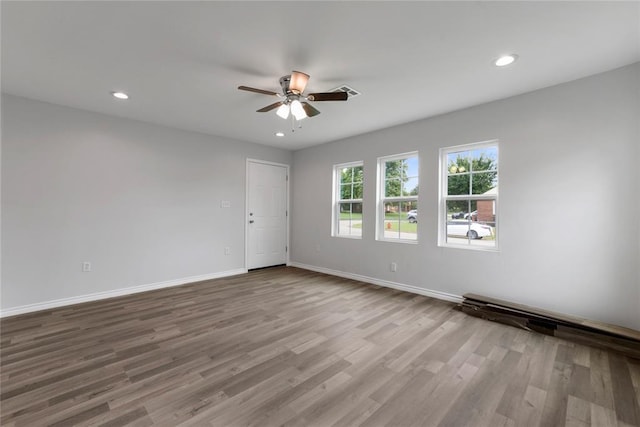 unfurnished room featuring recessed lighting, baseboards, a ceiling fan, and wood finished floors