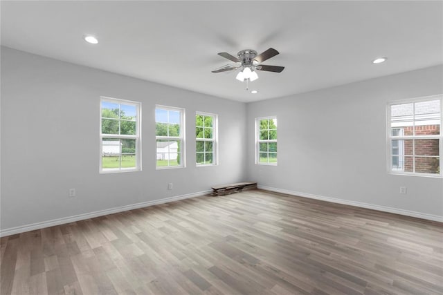unfurnished room with ceiling fan, recessed lighting, wood finished floors, and baseboards