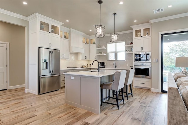 kitchen featuring stainless steel appliances, light countertops, ornamental molding, and open shelves